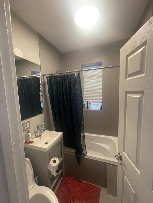 full bathroom with shower / tub combo, vanity, and toilet