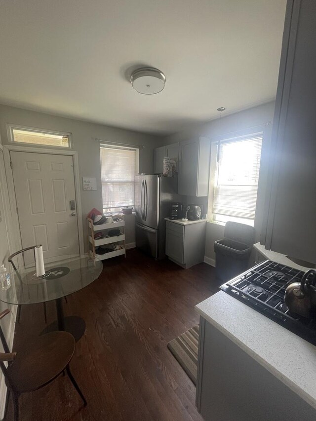 kitchen with gray cabinets, stainless steel fridge, and dark wood-type flooring