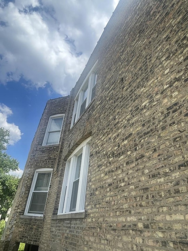 view of property exterior with brick siding