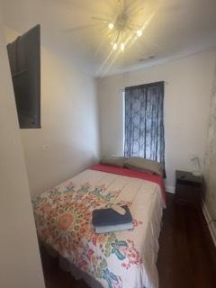 bedroom featuring ceiling fan and dark hardwood / wood-style flooring