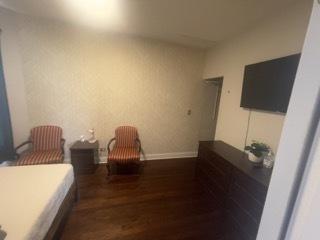 bedroom featuring dark wood-type flooring