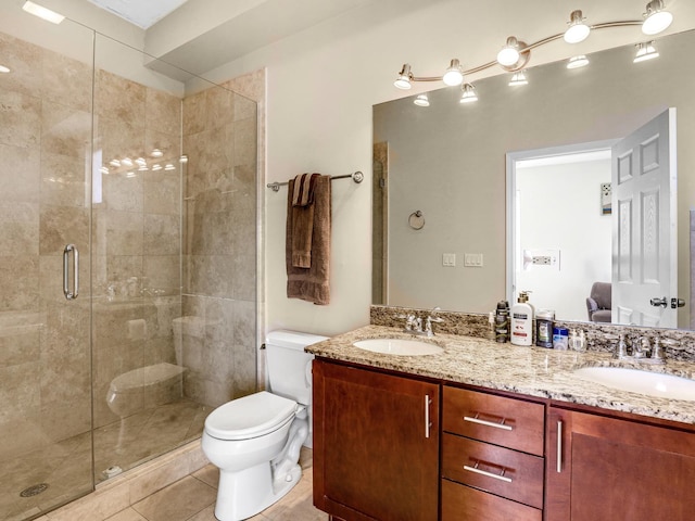 bathroom with tile patterned floors, a shower with door, vanity, and toilet