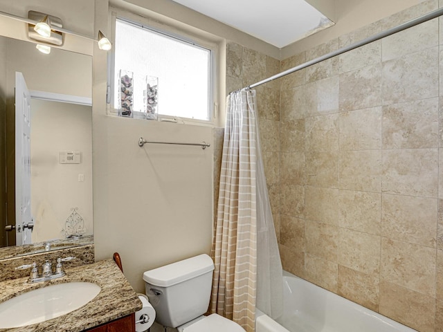 full bathroom featuring shower / bath combo with shower curtain, vanity, and toilet