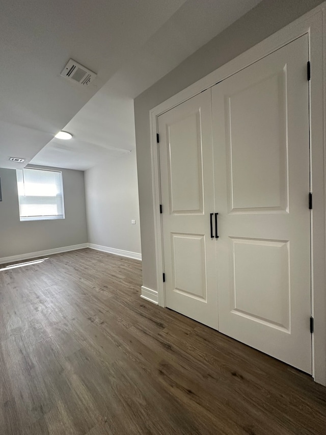 additional living space featuring dark hardwood / wood-style flooring