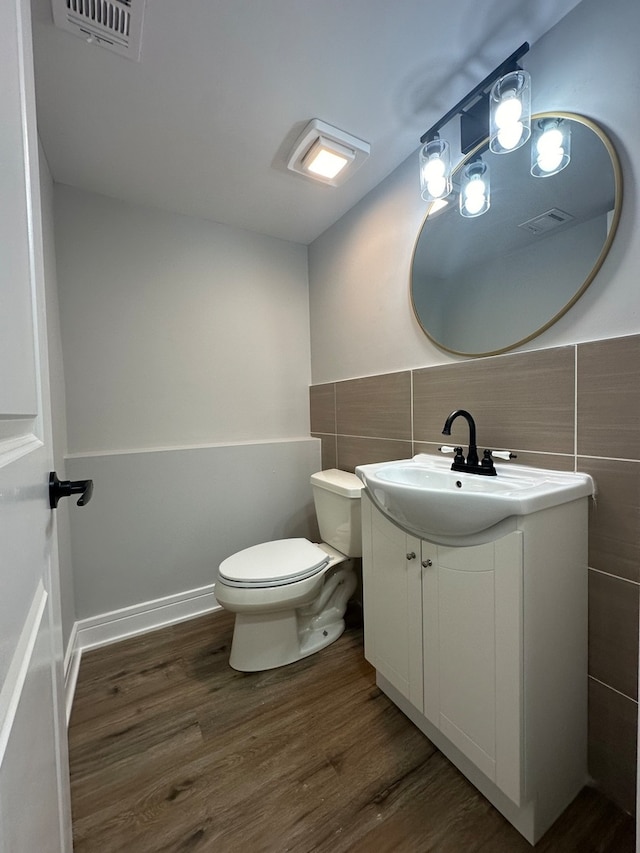 bathroom with wood-type flooring and tile walls