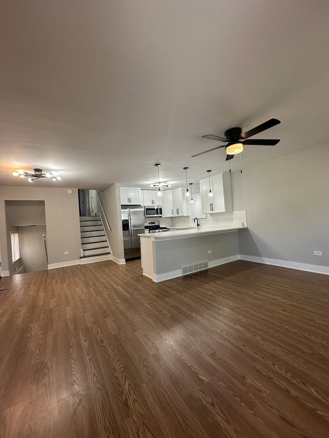 unfurnished living room with dark hardwood / wood-style flooring, ceiling fan, and sink