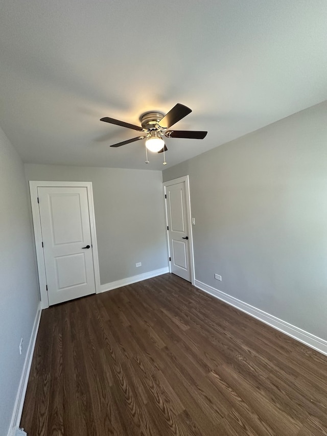 spare room featuring dark hardwood / wood-style floors and ceiling fan