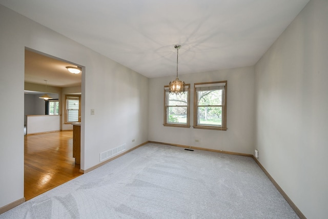 1553 Marquette Ave, Naperville, IL 60565 - unfurnished room with carpet flooring, baseboards, and a chandelier