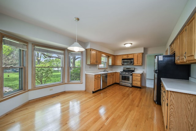 1553 Marquette Ave, Naperville, IL 60565 - kitchen with stainless steel appliances, light countertops, a sink, and light wood finished floors