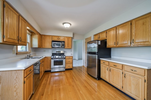 1553 Marquette Ave, Naperville, IL 60565 - kitchen with appliances with stainless steel finishes, a sink, light wood-type flooring, light countertops, and brown cabinets