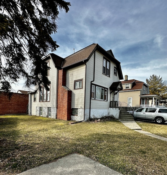 view of side of home featuring a lawn