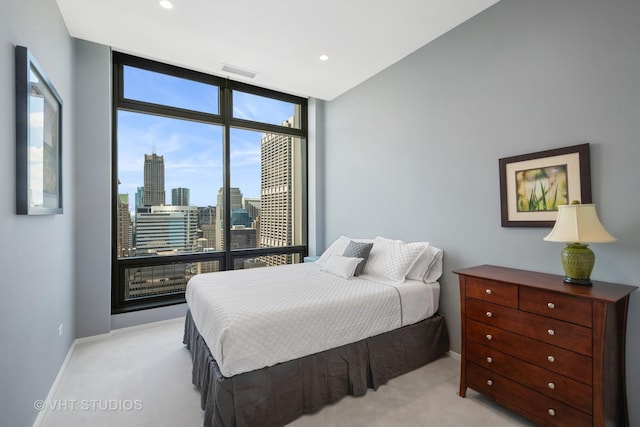 carpeted bedroom with floor to ceiling windows