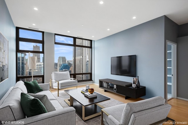 living room with light hardwood / wood-style floors and floor to ceiling windows