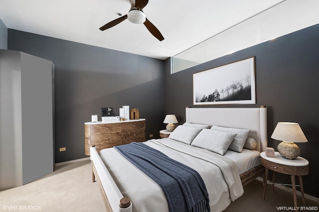 bedroom featuring ceiling fan and light carpet