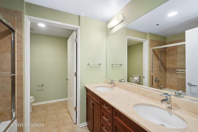 full bathroom with tile patterned flooring, vanity, toilet, and bath / shower combo with glass door