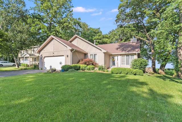 view of front of property with a garage and a front lawn