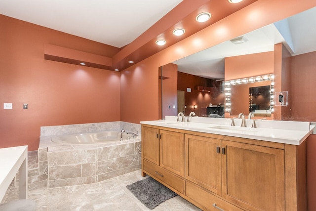 bathroom featuring vanity and a relaxing tiled tub