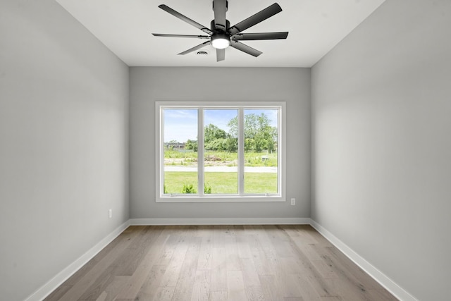 unfurnished room featuring baseboards, ceiling fan, and light wood finished floors