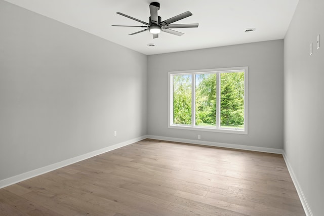 empty room featuring ceiling fan and light hardwood / wood-style floors