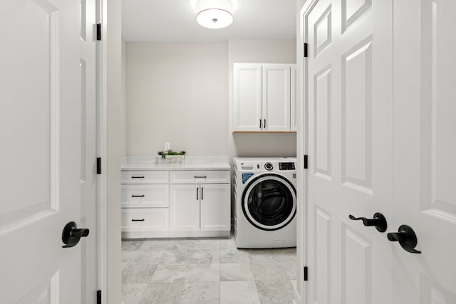 laundry room featuring cabinets, washer / dryer, and light tile floors