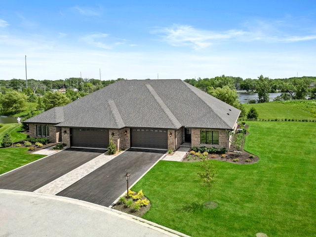 view of front facade with a front yard and a garage