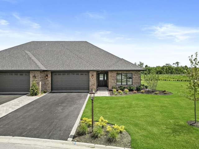 view of front facade featuring a shingled roof, driveway, a front lawn, and brick siding
