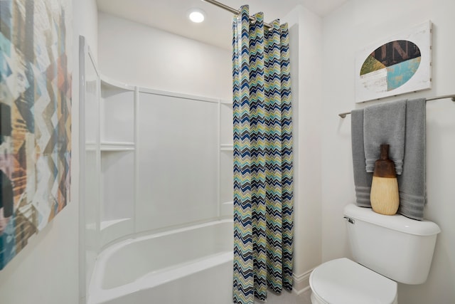 bathroom featuring shower / tub combo and toilet