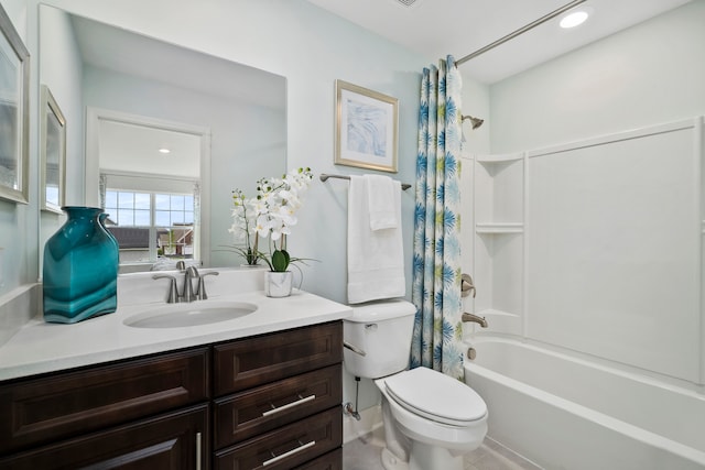 full bathroom with tile floors, shower / tub combo with curtain, vanity, and toilet