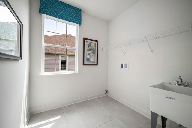 clothes washing area with sink, washer hookup, and light tile floors