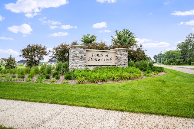 community / neighborhood sign with a lawn