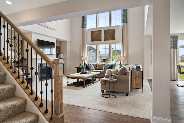 living room with a high ceiling and hardwood / wood-style flooring