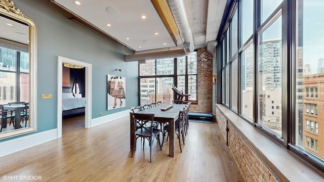 dining room featuring wood-type flooring and plenty of natural light