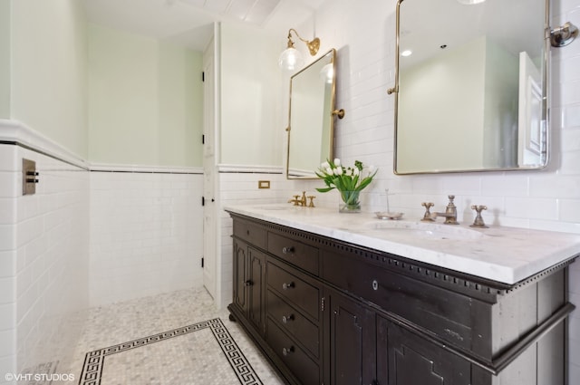 bathroom featuring tile flooring, tasteful backsplash, double sink, vanity with extensive cabinet space, and tile walls