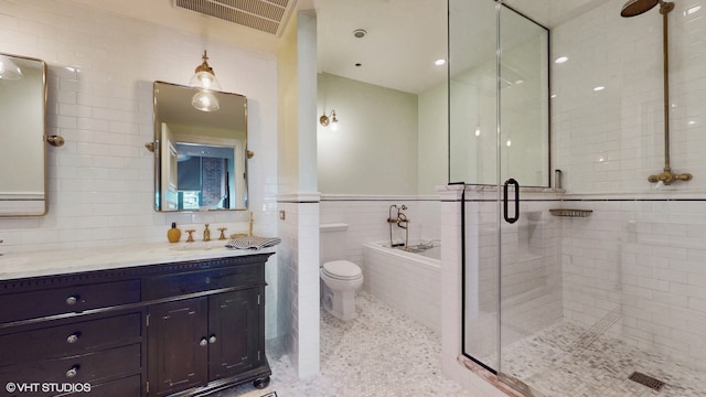 full bathroom featuring separate shower and tub, tile walls, tasteful backsplash, toilet, and large vanity