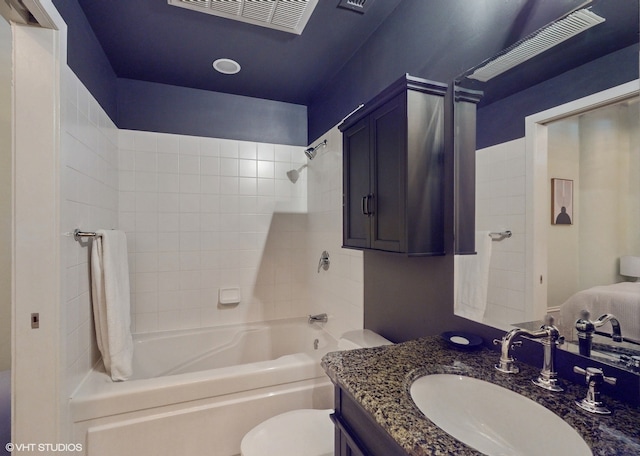 full bathroom featuring oversized vanity, toilet, and tiled shower / bath combo