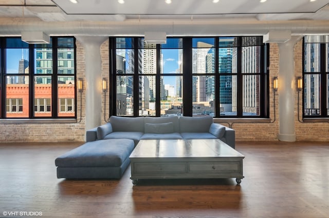 interior space featuring hardwood / wood-style flooring and brick wall