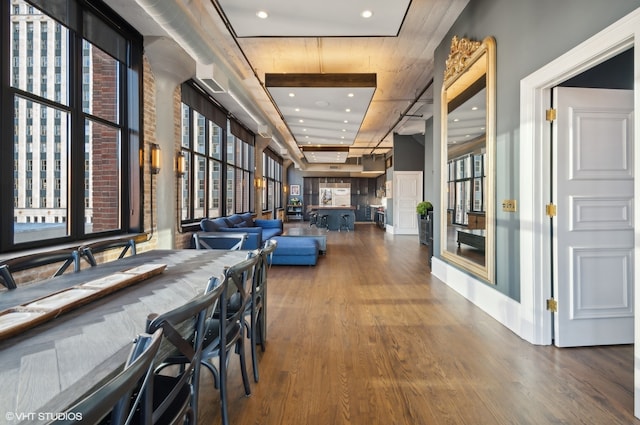 hall with a raised ceiling and hardwood / wood-style floors