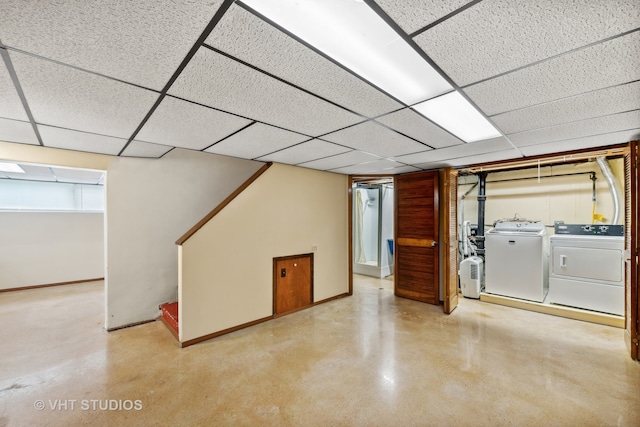 basement with washing machine and clothes dryer and a drop ceiling