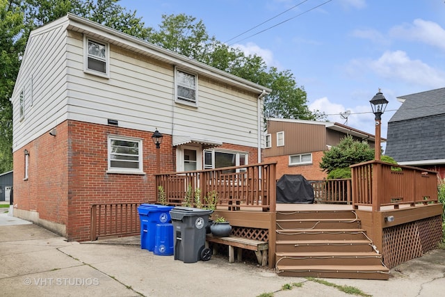 back of house featuring a wooden deck