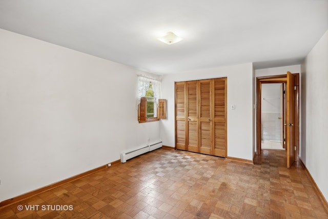 unfurnished bedroom with light parquet flooring, a closet, and a baseboard radiator