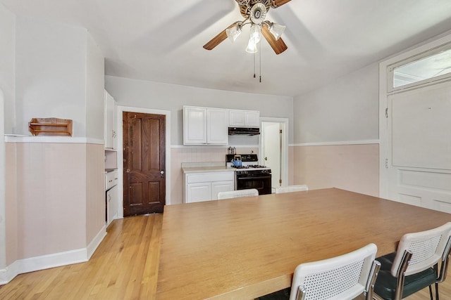 dining space with ceiling fan and light wood-type flooring