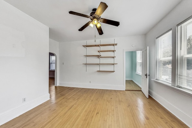 unfurnished living room featuring ceiling fan and light wood-type flooring