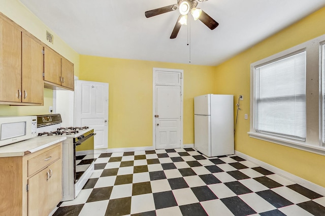 kitchen featuring ceiling fan, light brown cabinets, and white appliances