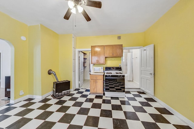 kitchen featuring ceiling fan and white appliances