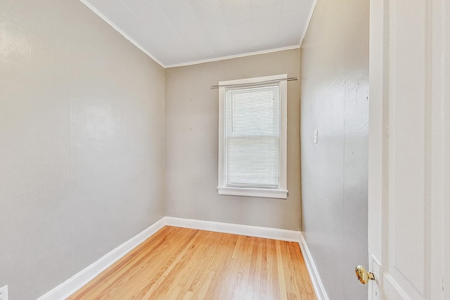 unfurnished room featuring hardwood / wood-style floors and ornamental molding