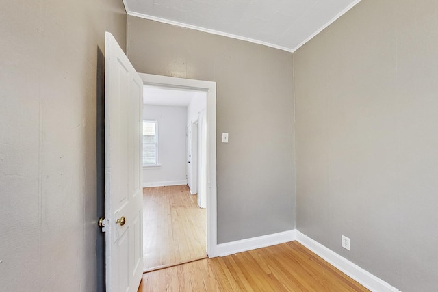 empty room featuring ornamental molding and hardwood / wood-style flooring