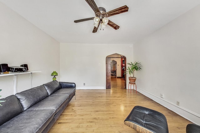 living room with ceiling fan and light hardwood / wood-style flooring