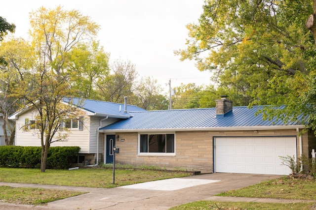 view of front of home with a front yard and a garage