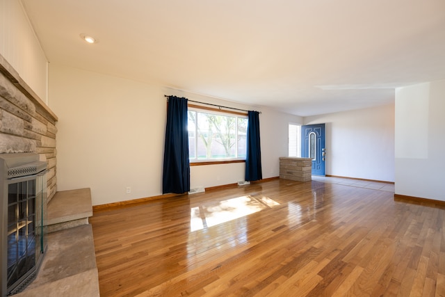 unfurnished living room featuring a fireplace and hardwood / wood-style flooring