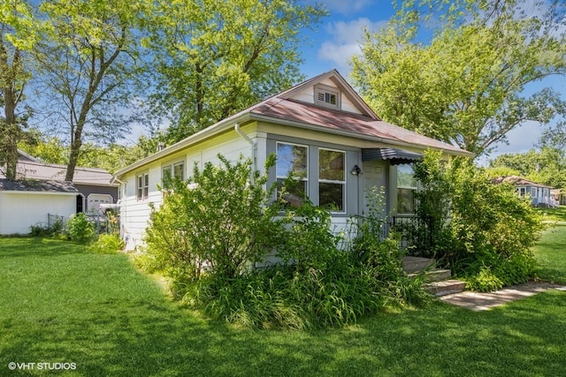 view of property exterior with a yard